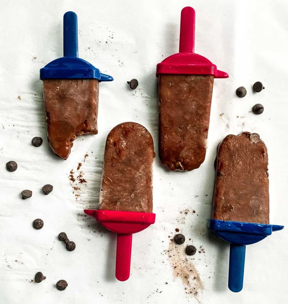 4 chocolate popsicles on parchment paper