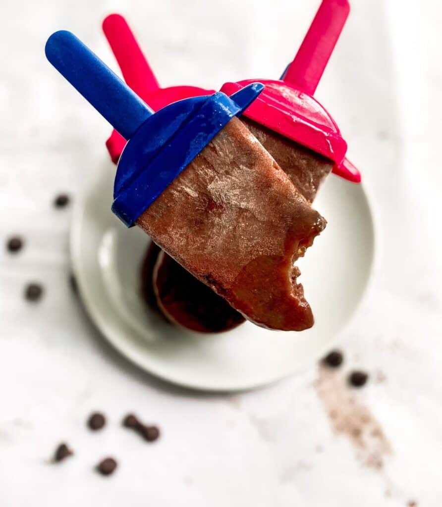 healthy chocolate popsicles stacked on a white plate