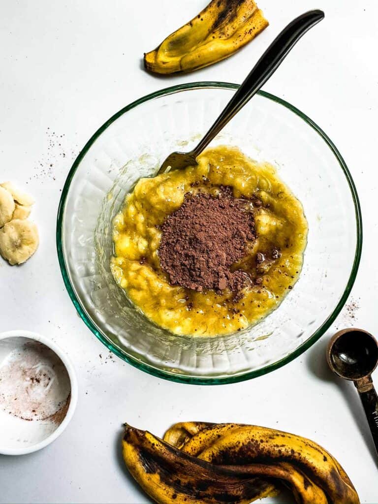mashed bananas in a bowl with cacao powder