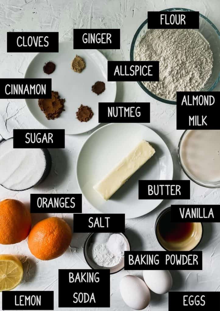 Ingredients for spiced orange muffins with labels (see recipe for details)