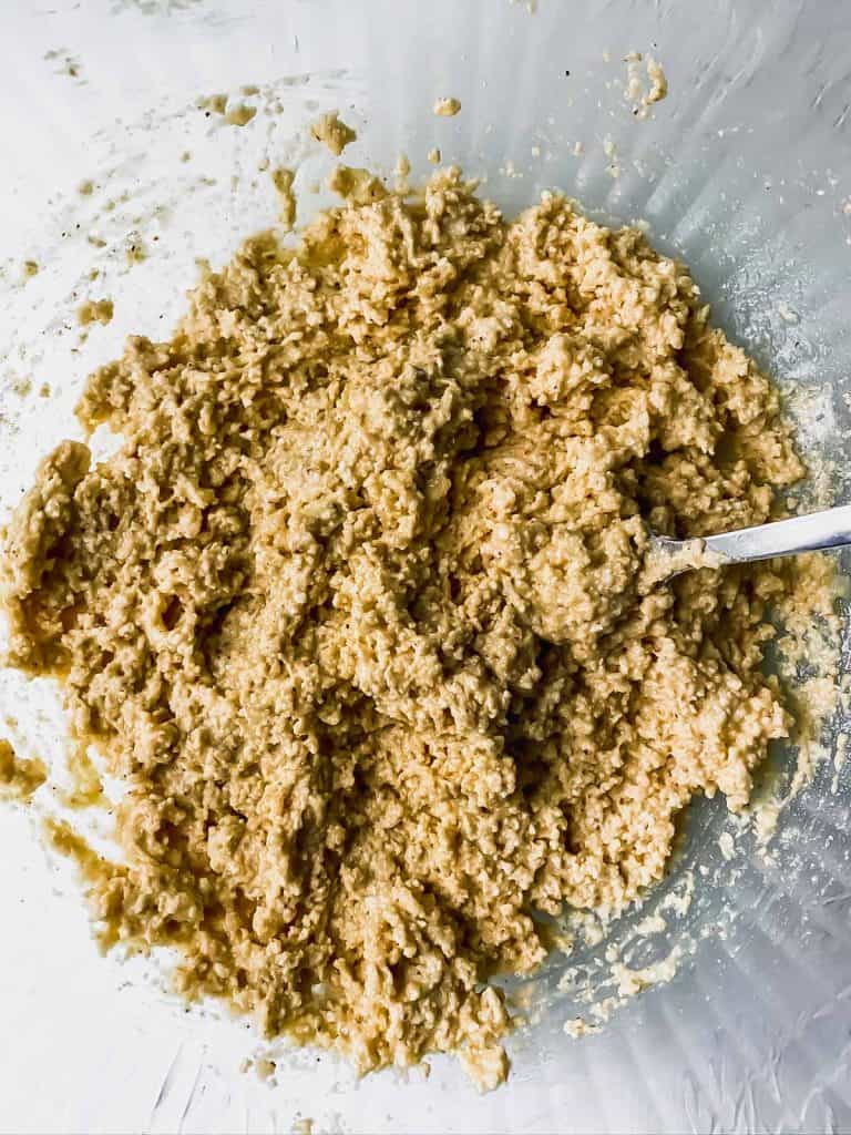 mixed matzo ball batter in a glass bowl