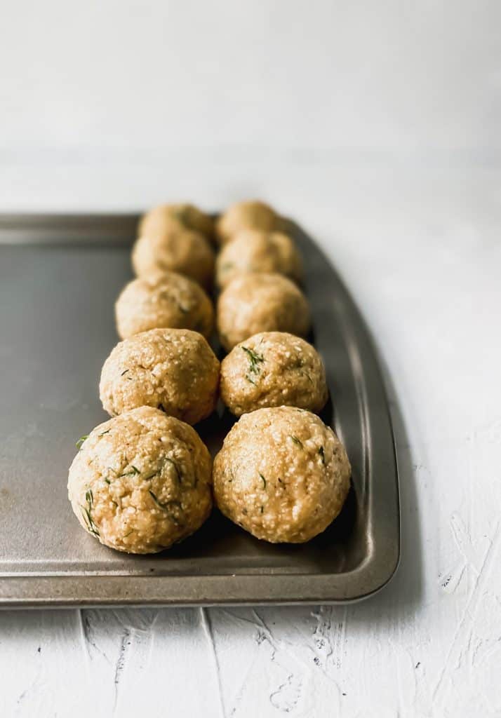 raw matzo balls on a baking pan
