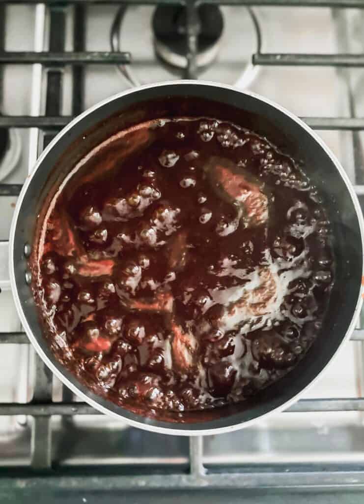 pomegranate juice reducing on the stove