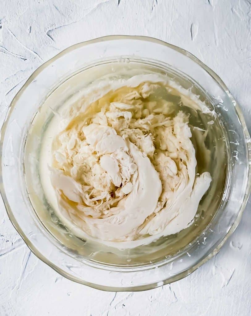 almond milk, lemon juice, and orange juice swirled in a glass bowl